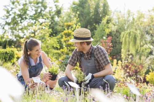 Gardeners assessing a large riverside garden for cubic-yard waste estimate